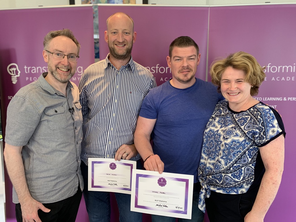 NLP diploma graduates celebrating with certificates